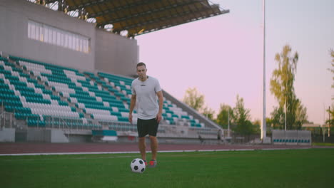 Professional-soccer-player-is-juggling-a-ball.-socker-a-player-in-a-white-football-uniform-at-the-stadium